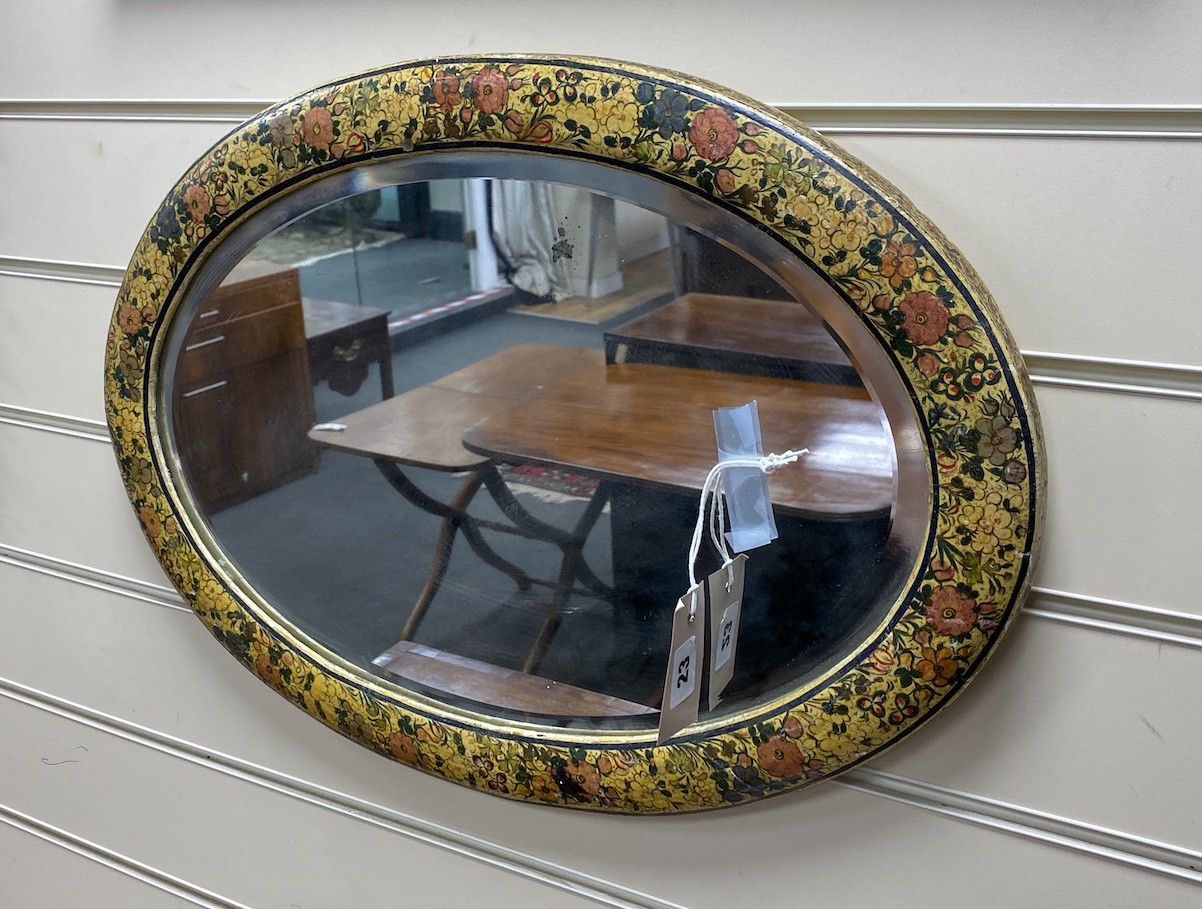 An Indian painted oval wall mirror, width 54cm, height 38cm